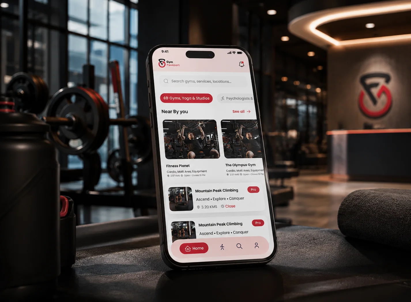 Gym Passport app on a phone in a gym, showing nearby gyms and classes
